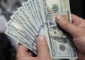 Dollar weakens as US stock futures gain on improved risk sentiment