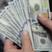 Dollar weakens as US stock futures gain on improved risk sentiment